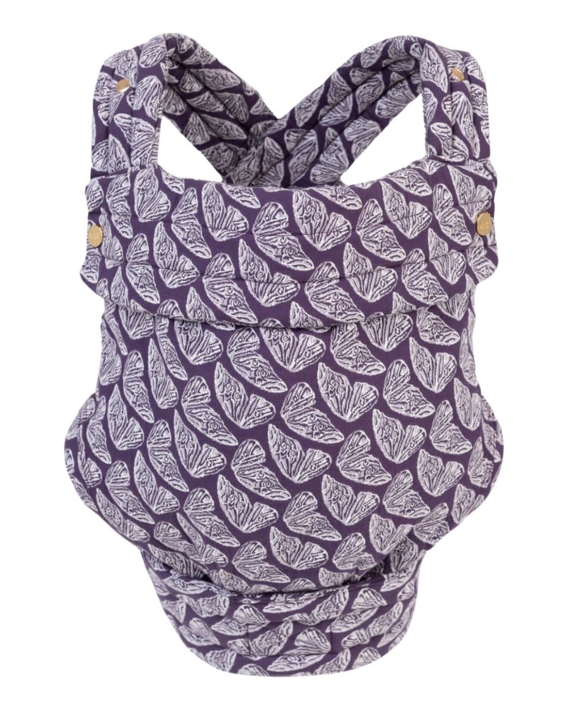 The Mabē Monarch Buckle Carrier in Violet Wings, which is purple and natural butterfly-wing-patterned cotton/linen fabric.