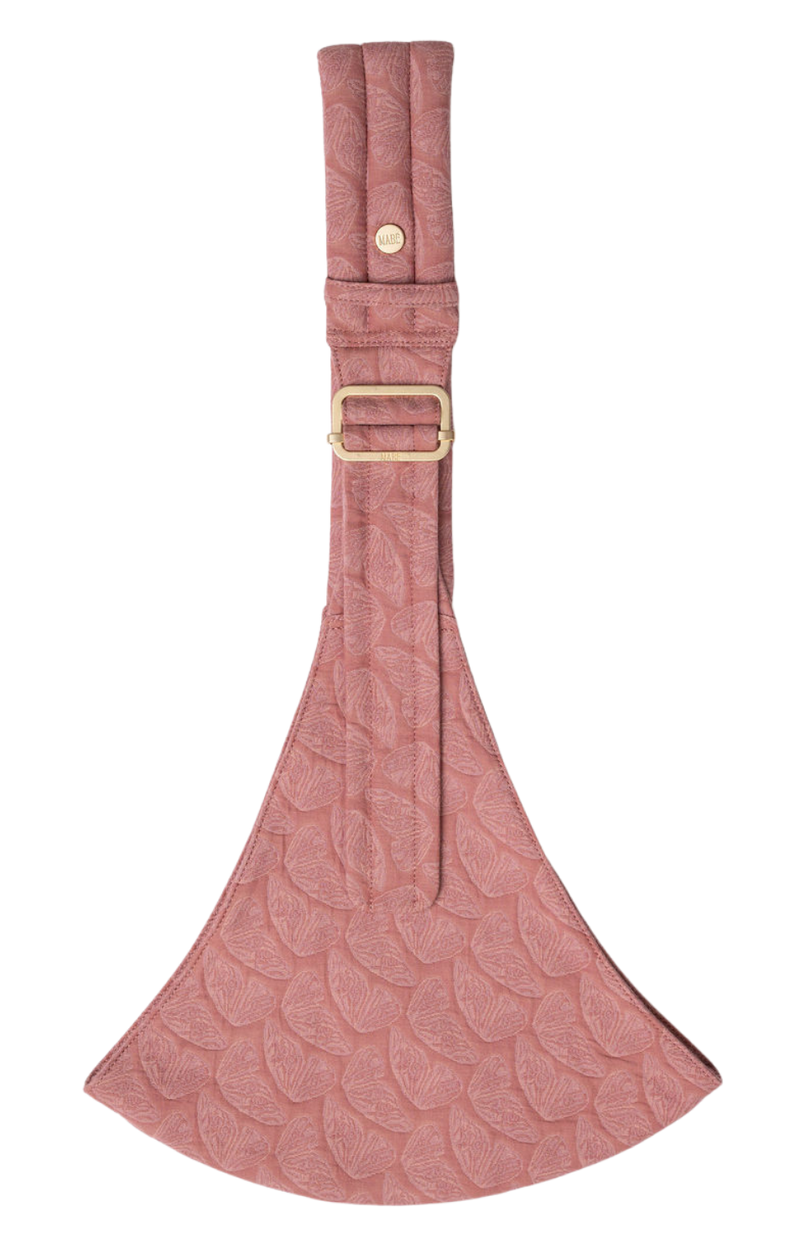 The Mabē Monarch Toddler Sling in Mauve Wings, which is pink butterfly-wing-patterned cotton/linen fabric.