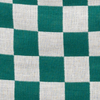 Close-up image of Mabē's jacquard weave Evergreen Check bluey-green and white checkered cotton/linen fabric