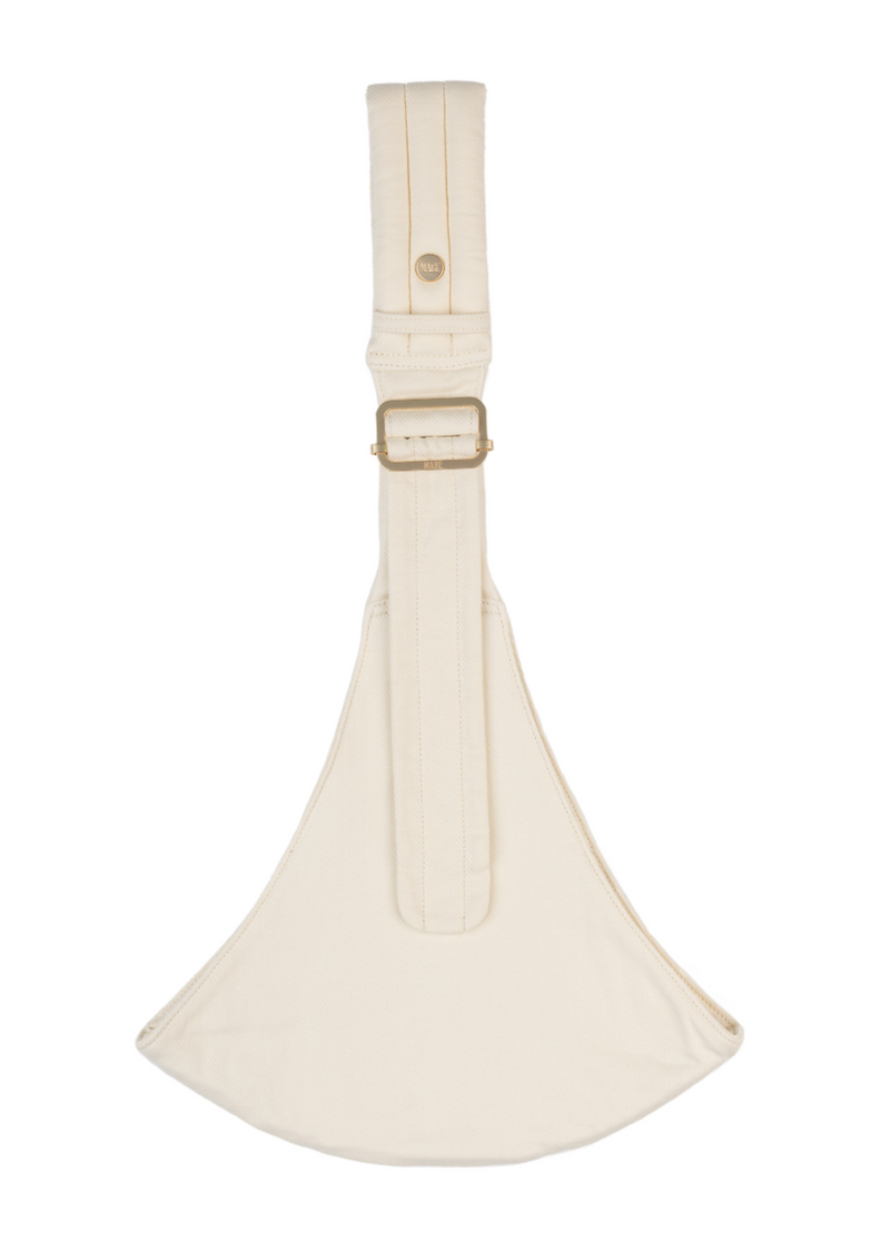 The Mabē Monarch Toddler Sling in Stone Sage, which is solid ivory cotton/linen fabric.
