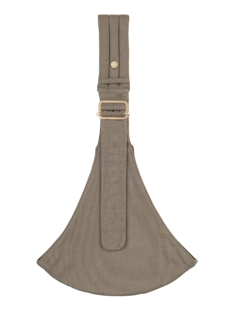 The Mabē Monarch Toddler Sling in Stone Sage, which is solid greenish gray cotton/linen fabric.