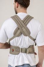 Back view of a man wearing the Mabē Monarch Buckle Carrier in Charles Herringbone, which is a delicate herringbone weave cotton/linen fabric in shades of brown.
