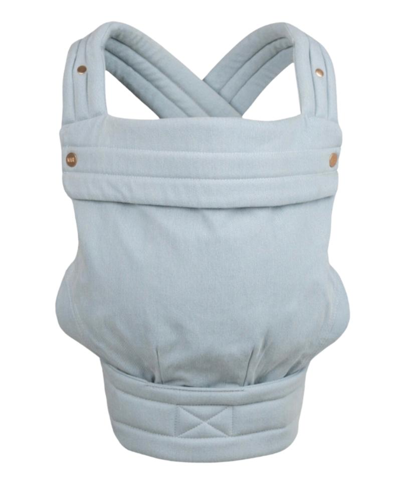 The Mabē Monarch Buckle Carrier in Dream Wash Denim, which is solid light blue denim cotton fabric.