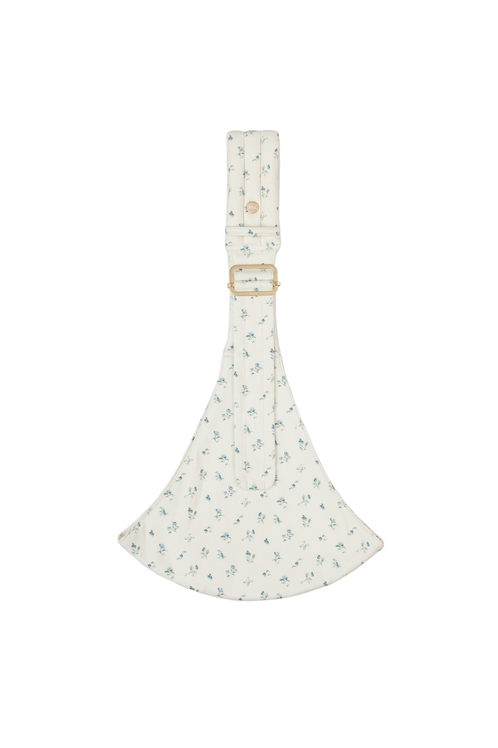The Mabē Monarch Toddler Sling in Sunday Floral, white cotton/linen fabric with delicate sprigs of blue flowers, gold branded button and ladder lock buckle, and quilted crossbody shoulder strap.