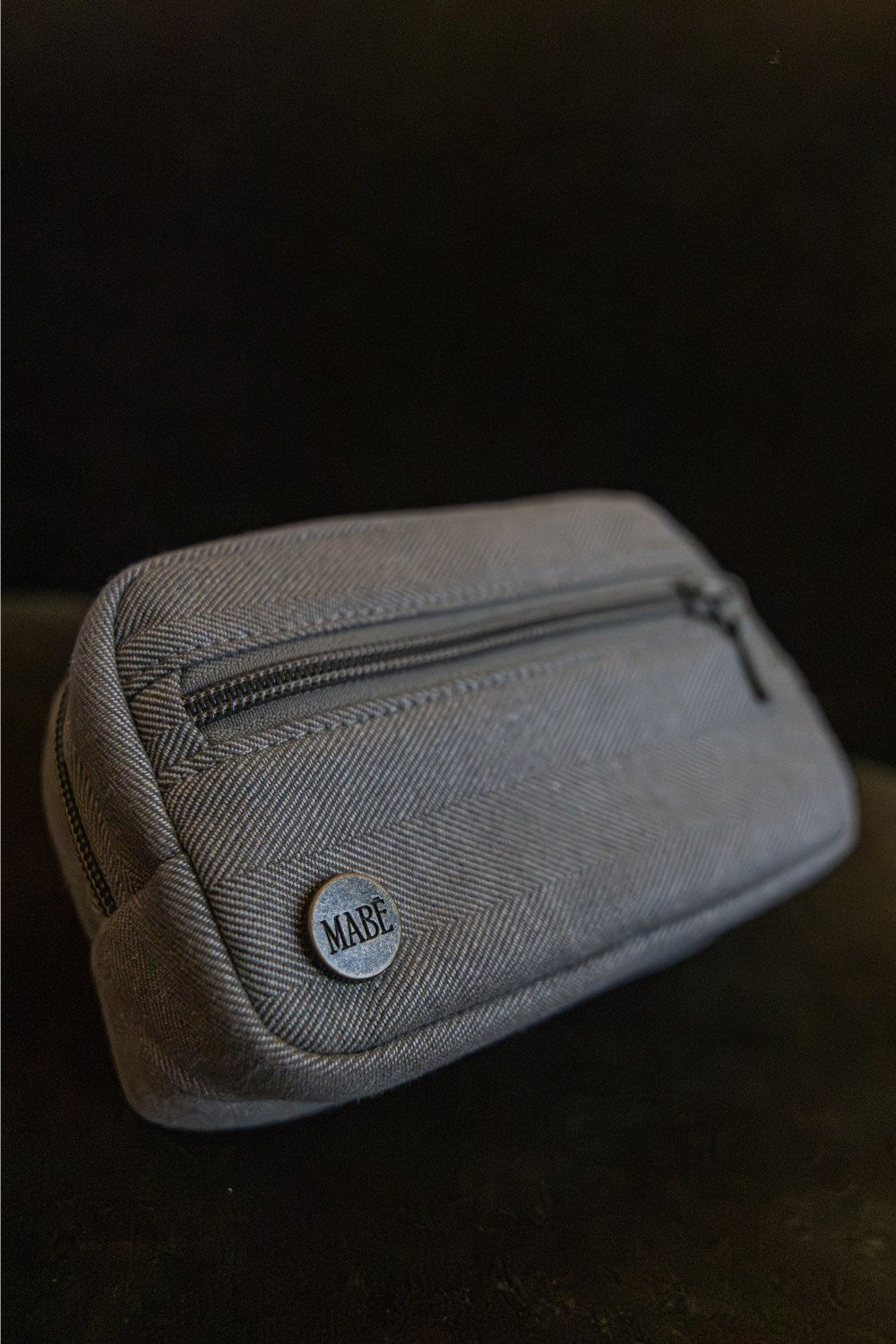 The Mabē Accessory Bag in Charles Herringbone, which is a delicate herringbone weave in shades of brown.