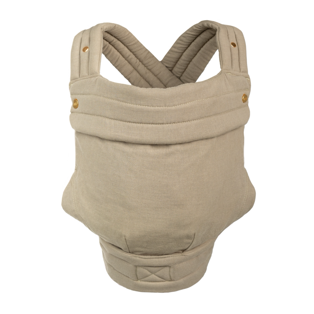 The Mabē Monarch Buckle Carrier in Stone Sage, which is a solid warm sage-tinged stone color cotton/linen fabric with gold branded snaps.