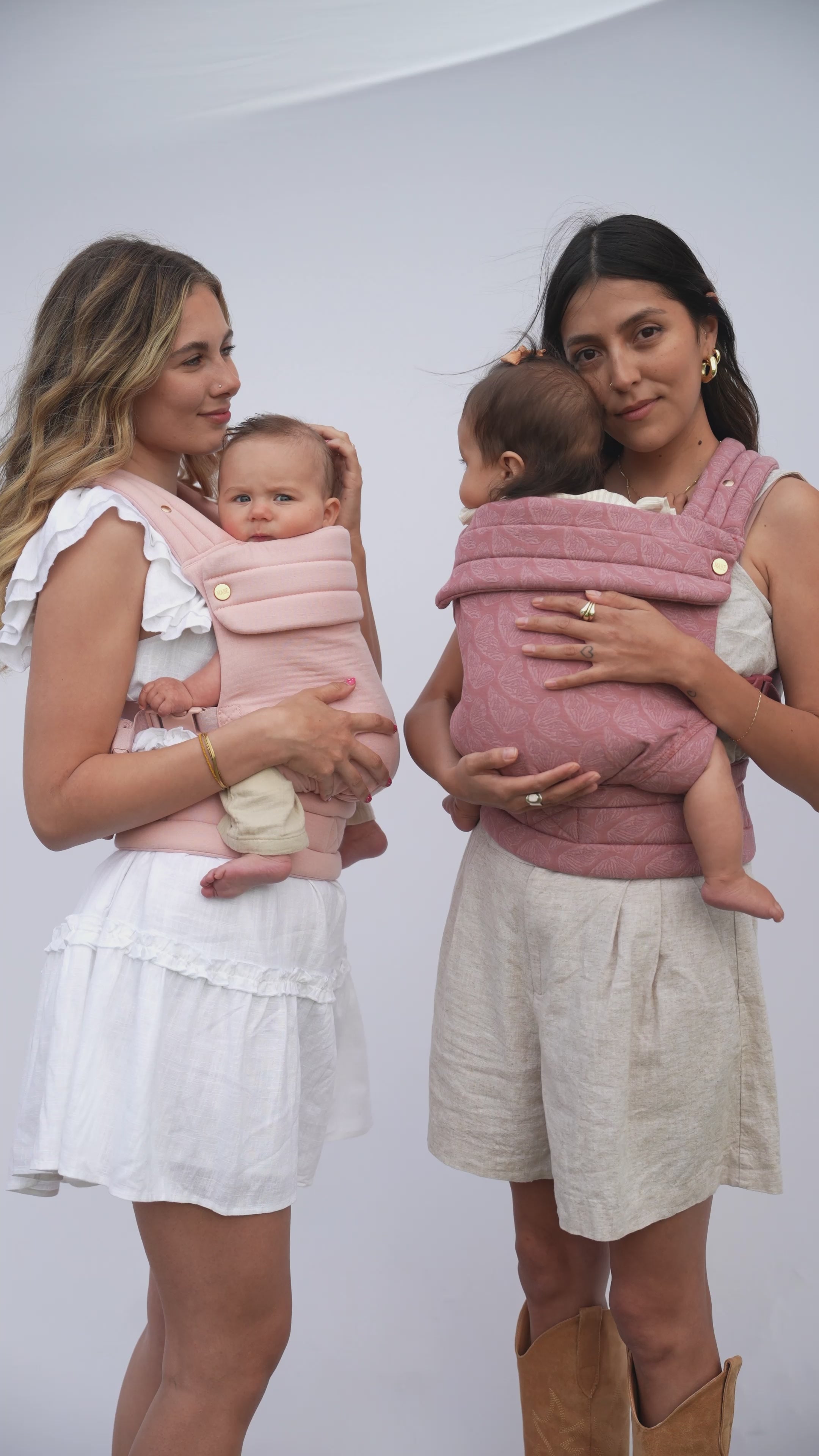 Video of two moms wearing their babies in Mabē Monarch Baby Carriers with the hand-drawn butterfly print.