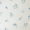Close-up of the Mabē Monarch Sunday Floral fabric, which is ivory twill cotton/linen with tiny sprigs of blue flowers.